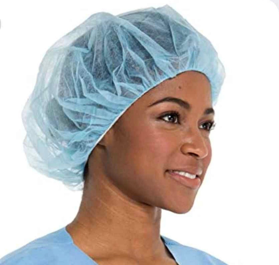 Disposable blue bouffant cap worn by dental professional